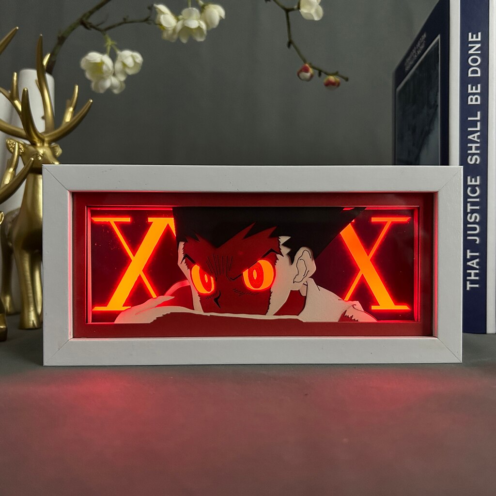 Layered cut paper lamp featuring Gon Freecss on red light setting